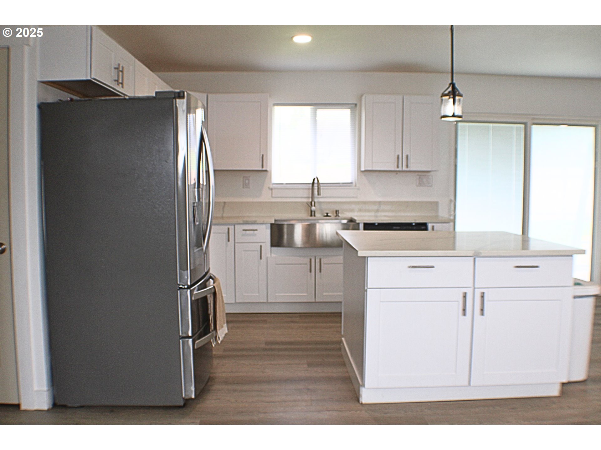 616 4th Avenue Riddle, OR 97469 - Photo 4 of 36 a kitchen with kitchen island white cabinets and refrigerator