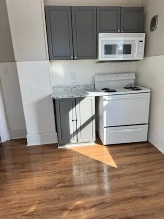 a kitchen with a stove and a microwave