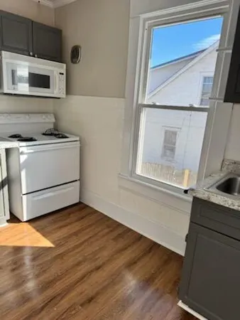 a kitchen with a stove microwave and a sink