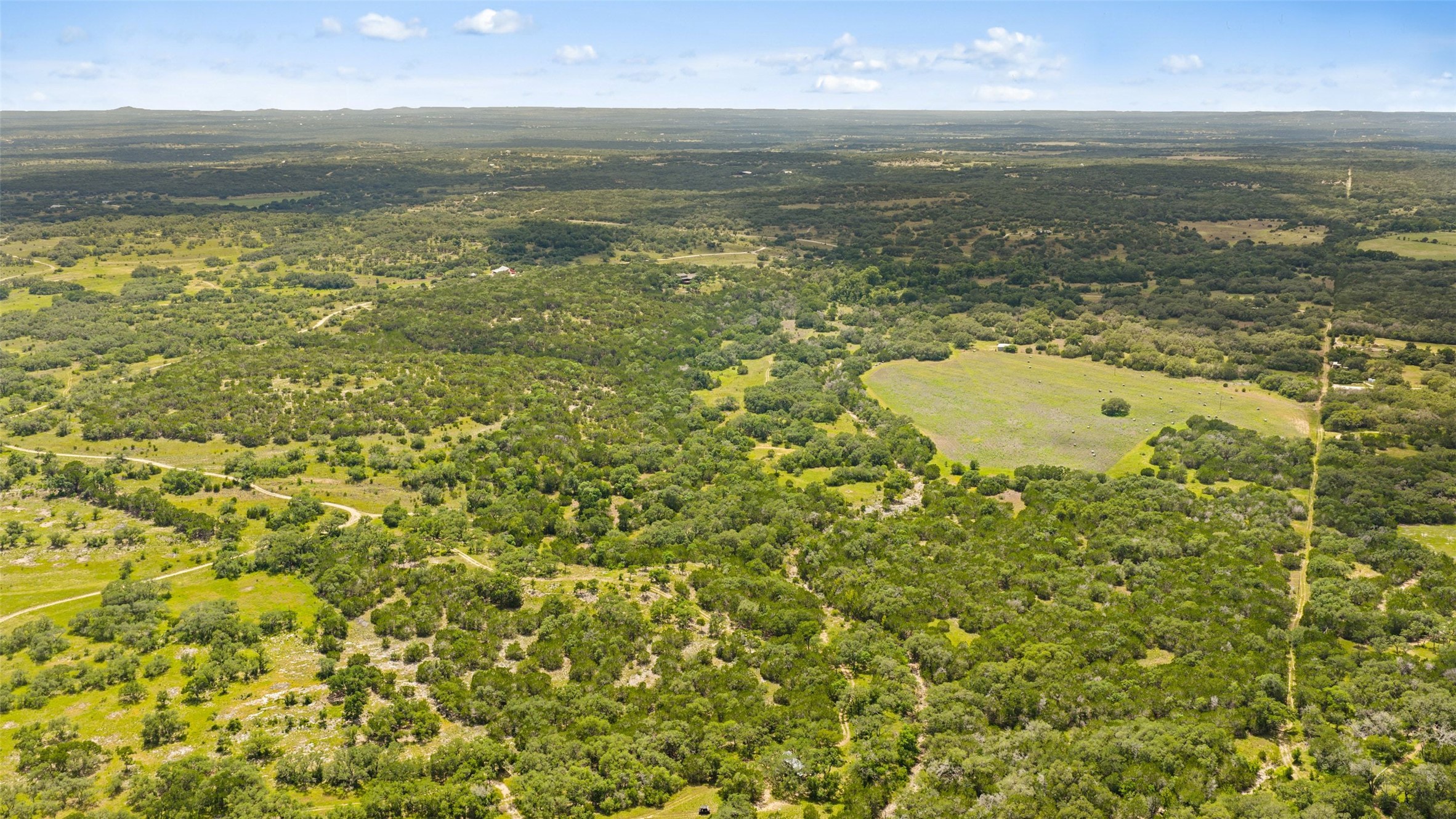 505 Red Corral Ranch Road Wimberley, TX 78676 - Photo 14 of 40 Discover expansive land offering natural tranquility and verdant surroundings for ultimate privacy.