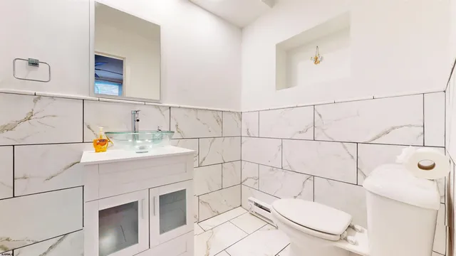 a bathroom with a sink a toilet and mirror