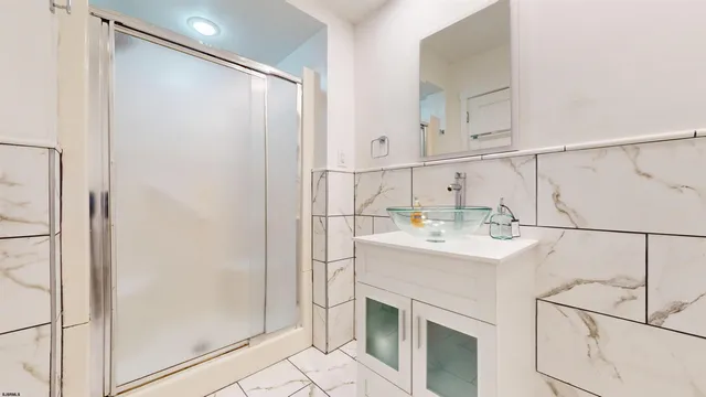 a kitchen with a sink a refrigerator and cabinets
