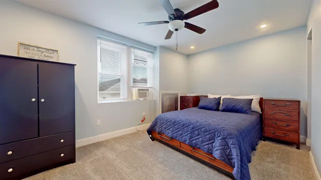 a bedroom with a bed and a dresser