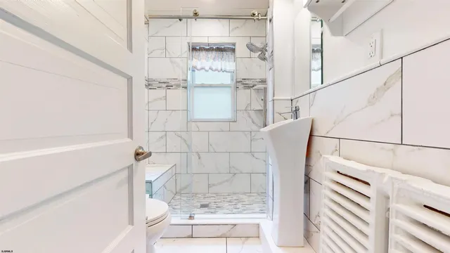 a bathroom with a bathtub and shower