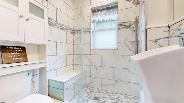 a bathroom with a toilet sink and shower