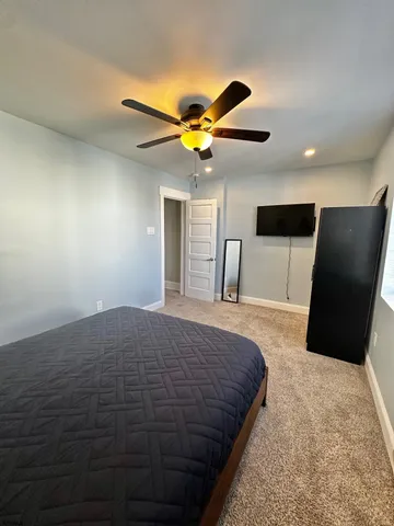 a bedroom with a bed and a chandelier