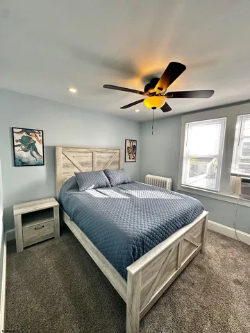 a bed sitting in a bedroom next to a window