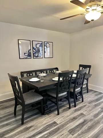 a view of a dining room with furniture and wooden floor