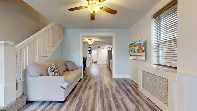 a living room with furniture and a chandelier