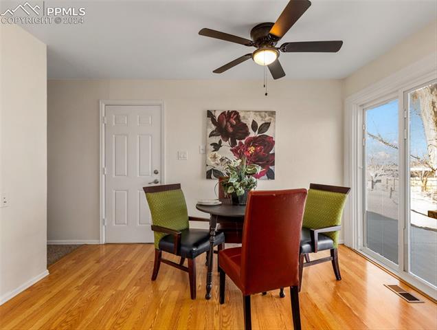 142 Mac Neil Road Pueblo, CO 81001 - Photo 12 of 24 Dining room featuring light wood-type flooring and ceiling fan