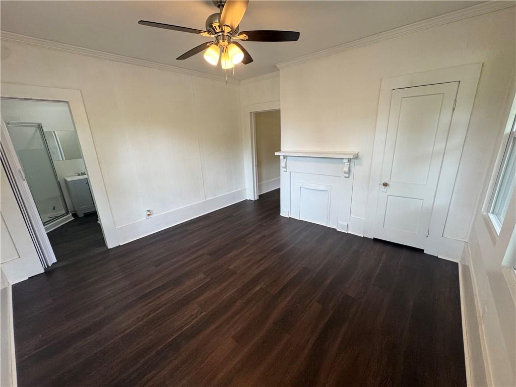 24 Lower Street Valley, AL 36854 - Photo 5 of 18 Unfurnished bedroom featuring crown molding, dark wood-type flooring, and a ceiling fan