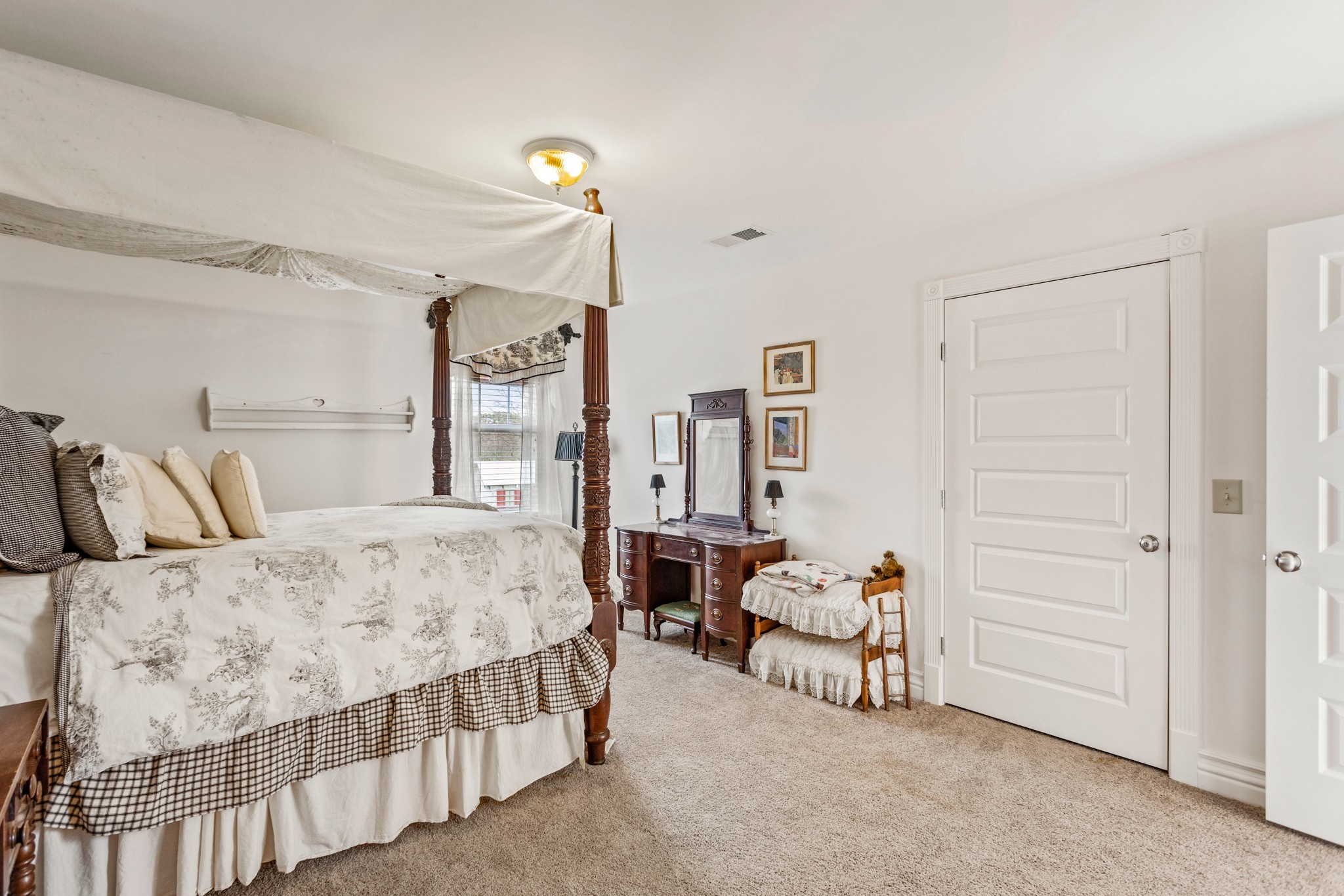 2833 Thompson's Station Road East Thompson's Station, TN 37179 - Photo 21 of 38 a bedroom with a bed and a chandelier