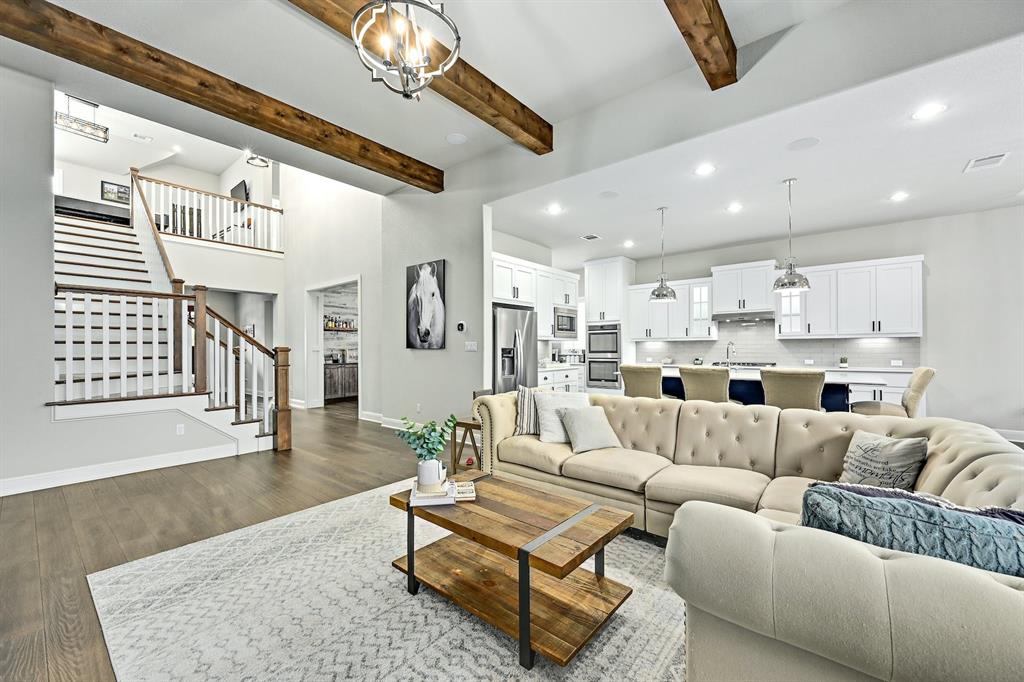 629 Germander Road Leander, TX 78641 - Photo 10 of 32 Exposed wood beams add architectural character to this open-concept living area with a bright, functional kitchen.