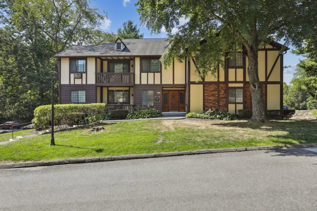 a front view of house with yard and green space
