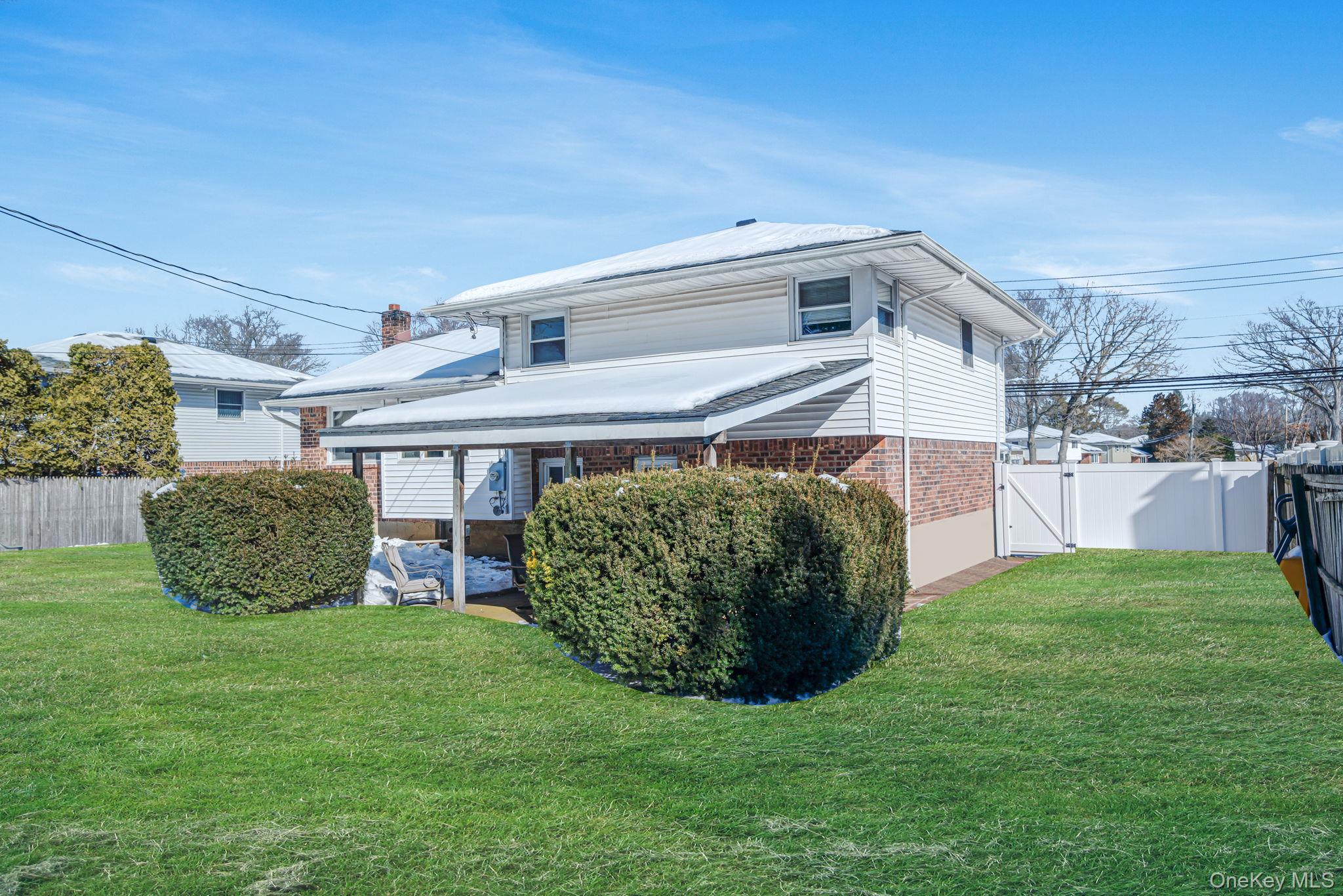 24 Kings Park Road Commack, NY 11725 - Photo 11 of 32 a view of a house with a yard and potted plants