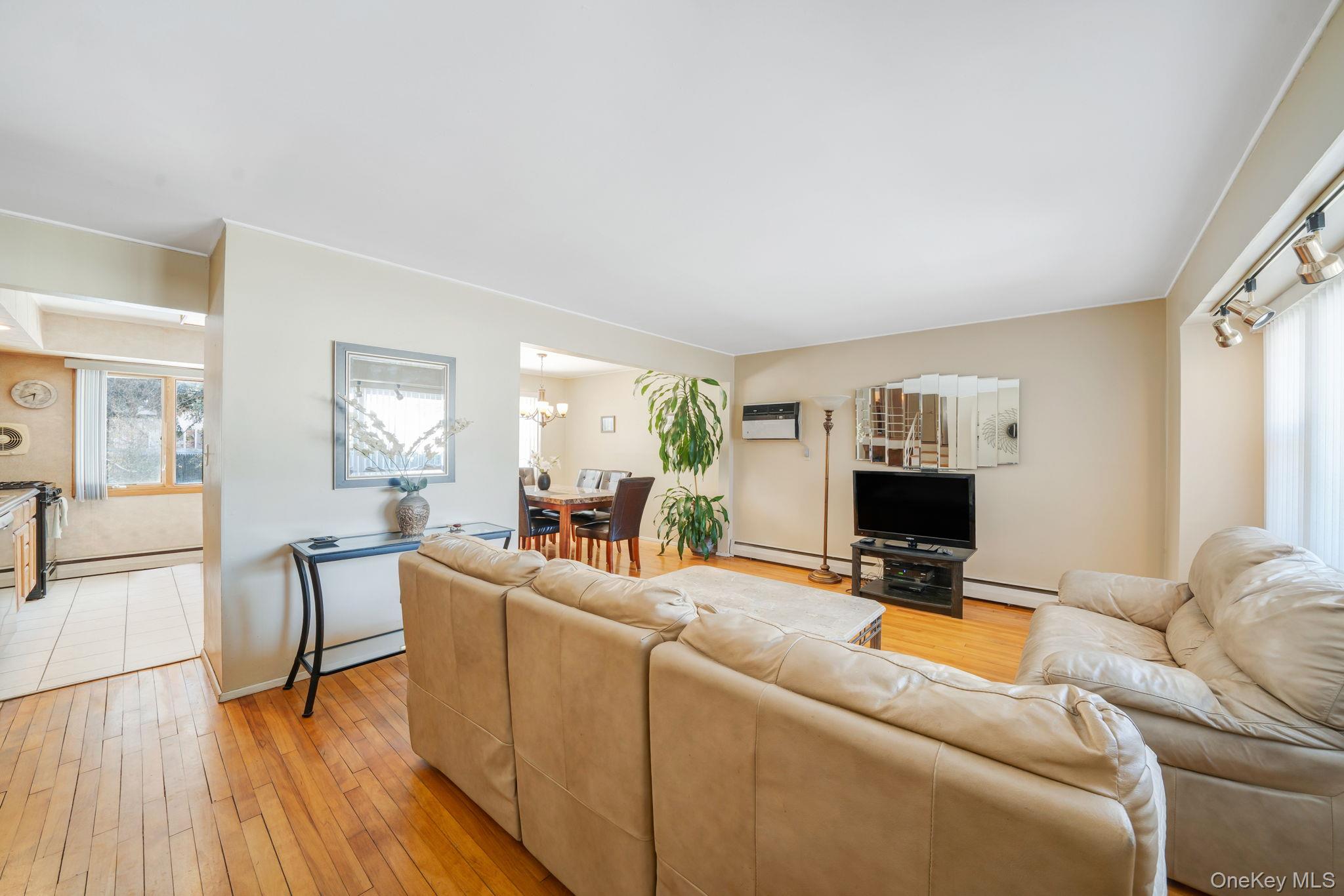 24 Kings Park Road Commack, NY 11725 - Photo 12 of 32 a living room with furniture a fireplace and a flat screen tv