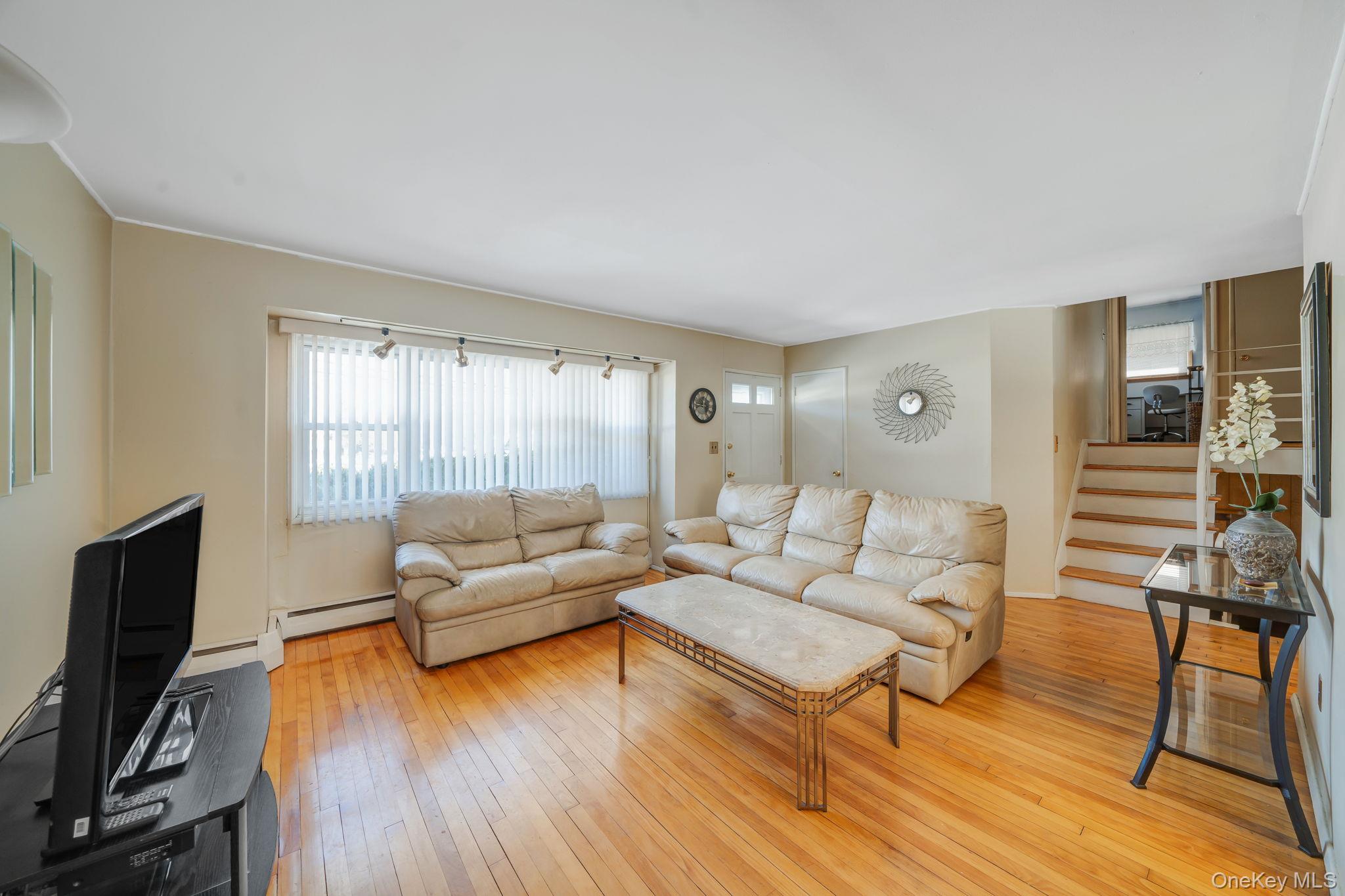 24 Kings Park Road Commack, NY 11725 - Photo 14 of 32 a living room with furniture and a flat screen tv