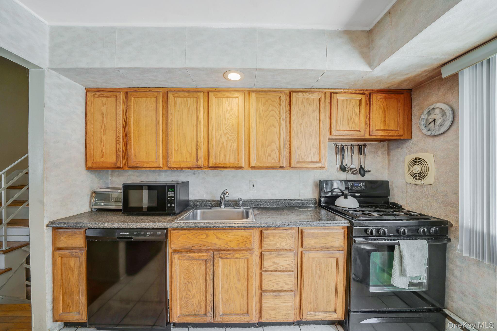 24 Kings Park Road Commack, NY 11725 - Photo 18 of 32 a kitchen with stainless steel appliances granite countertop a stove a sink and a microwave
