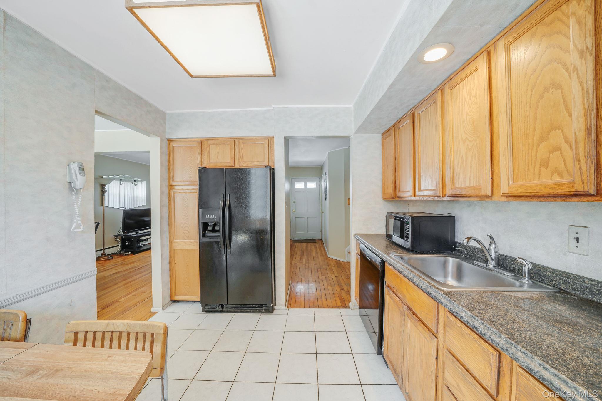 24 Kings Park Road Commack, NY 11725 - Photo 19 of 32 a kitchen with stainless steel appliances granite countertop a refrigerator and a sink