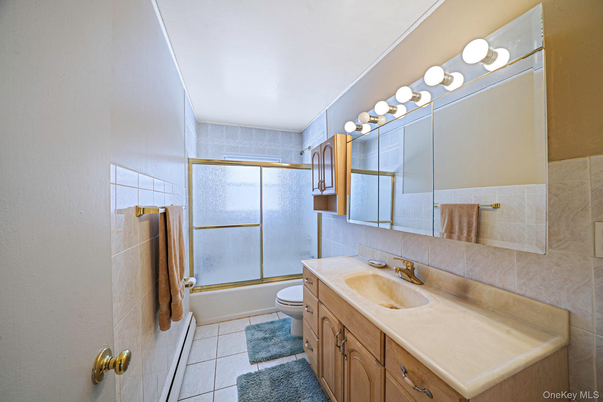 24 Kings Park Road Commack, NY 11725 - Photo 21 of 32 a bathroom with a sink double vanity and a mirror