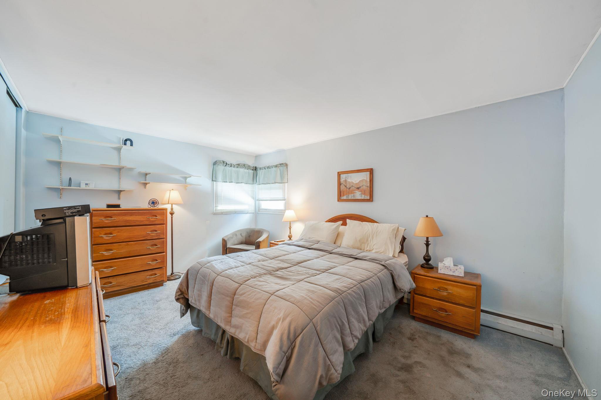 24 Kings Park Road Commack, NY 11725 - Photo 22 of 32 a bedroom with a bed and a cabinets