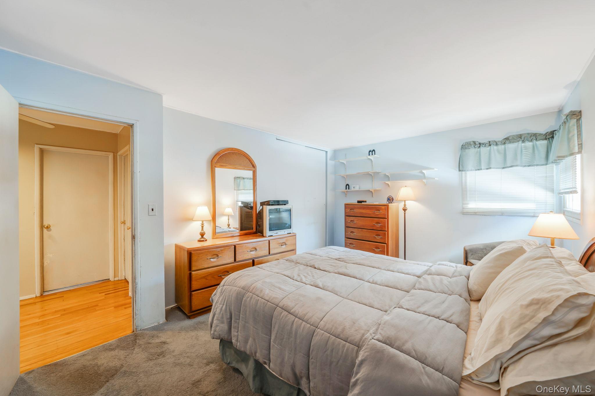 24 Kings Park Road Commack, NY 11725 - Photo 23 of 32 a bedroom with a bed and a view of living room