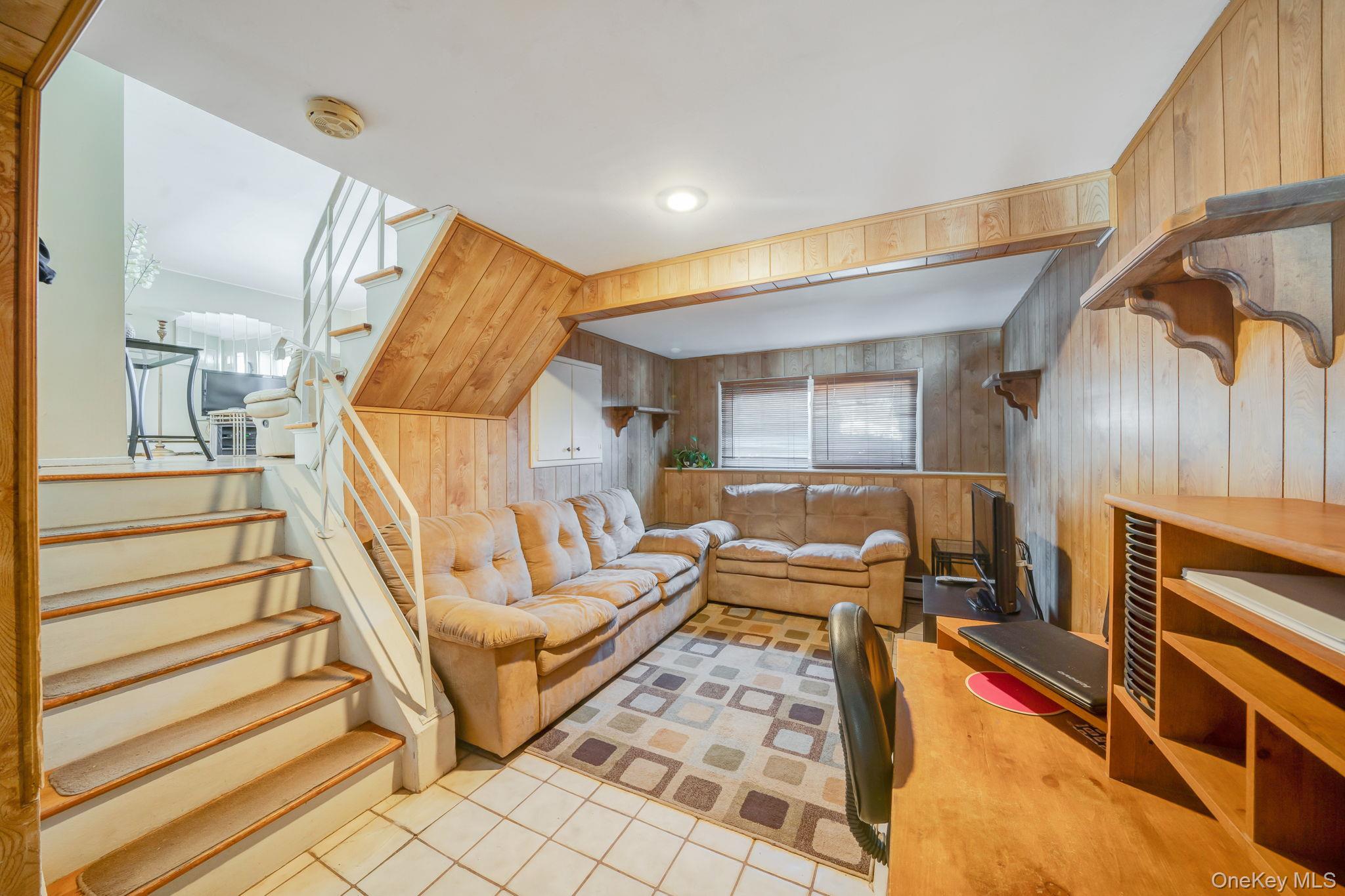 24 Kings Park Road Commack, NY 11725 - Photo 26 of 32 a living room with furniture and a fireplace