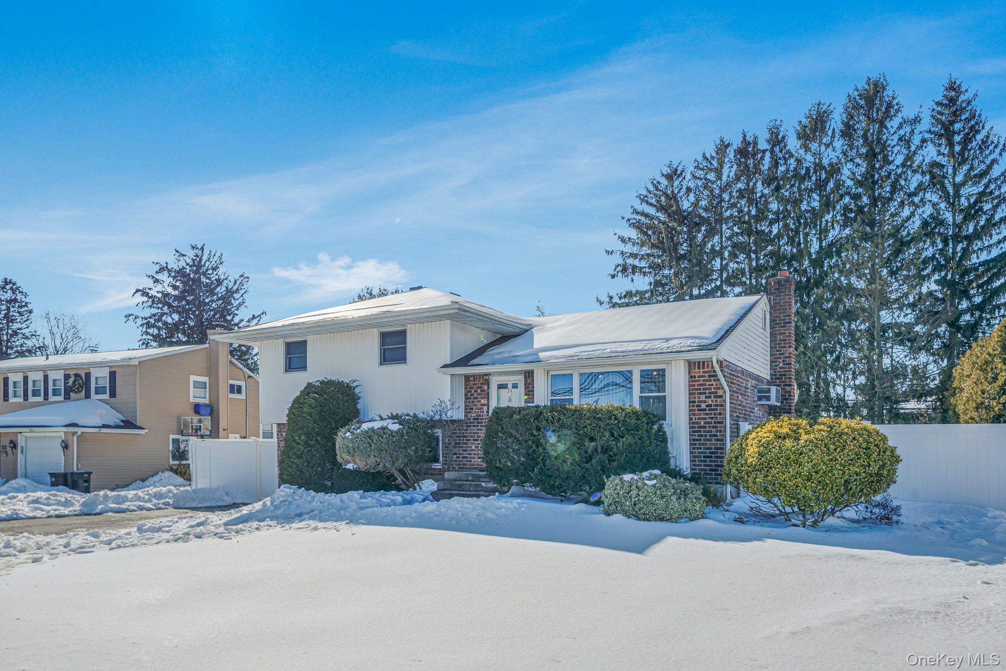 24 Kings Park Road Commack, NY 11725 - Photo 5 of 32 a front view of a house with a garden