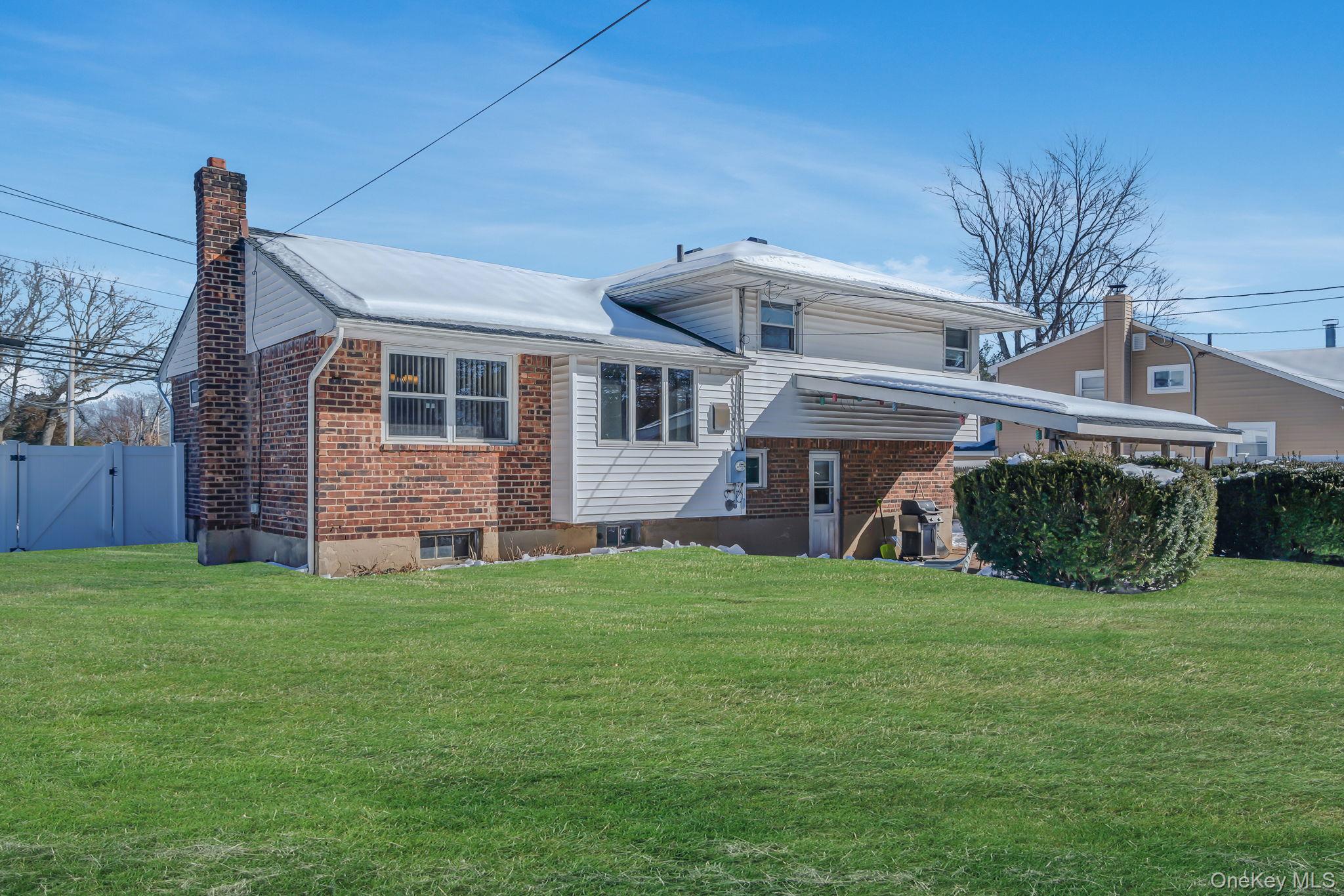 24 Kings Park Road Commack, NY 11725 - Photo 9 of 32 a view of a house with a yard