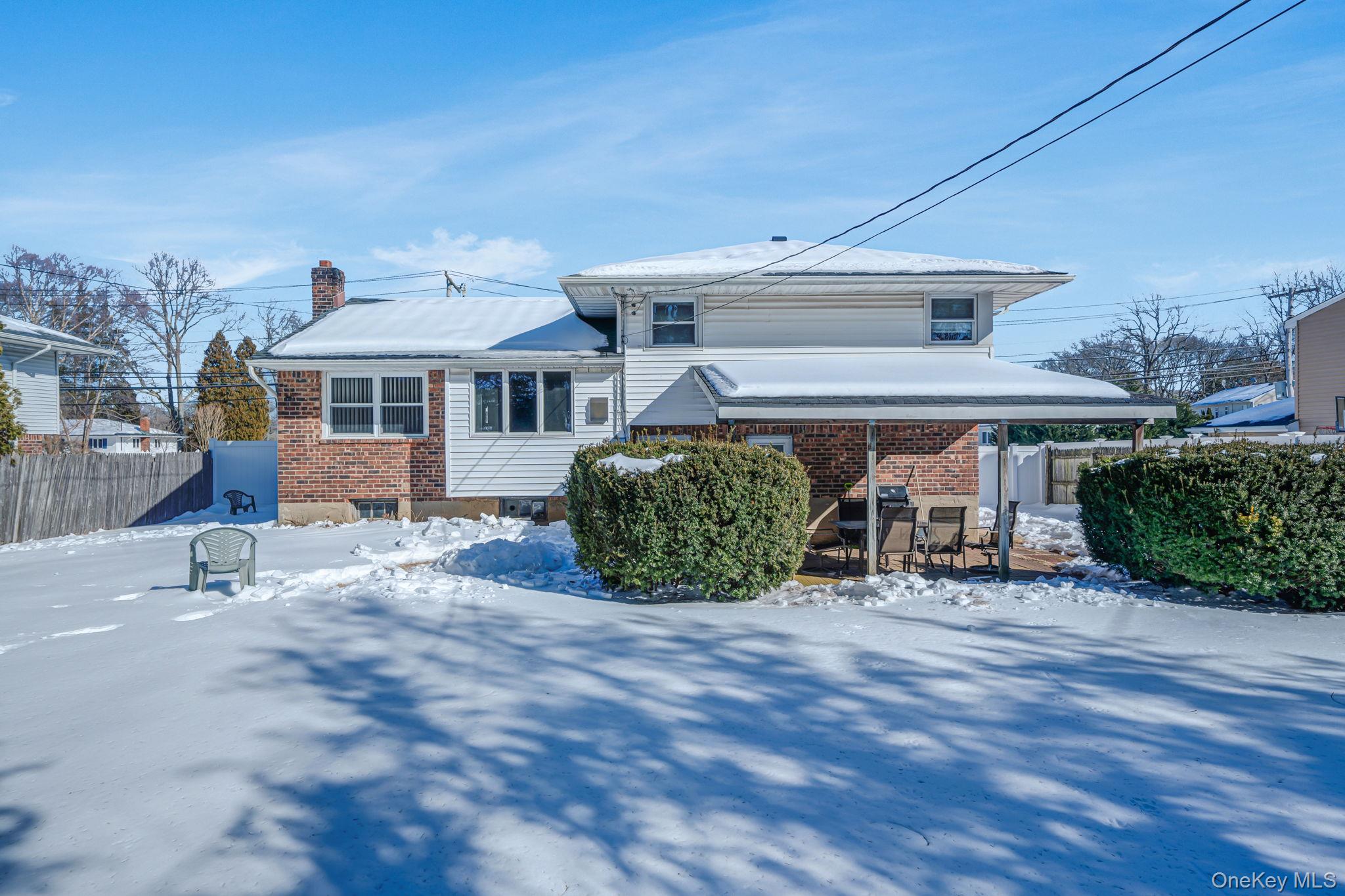 24 Kings Park Road Commack, NY 11725 - Photo 10 of 32 a view of a house with a patio