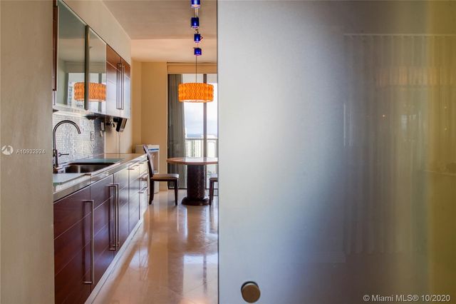 a kitchen with granite countertop a sink and a stove top oven