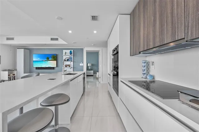 a dining room with furniture and a floor to ceiling window