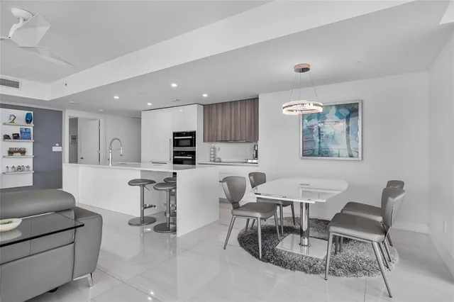 a spacious bedroom with a bed and a flat screen tv