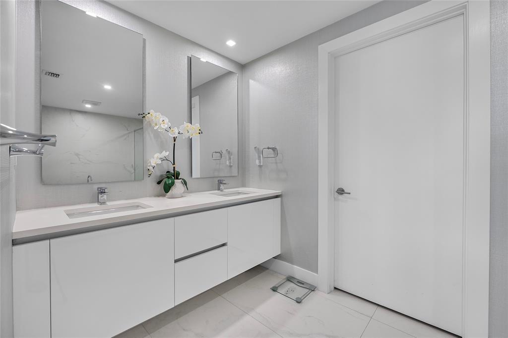 730 North Ocean Boulevard, Unit 1501 Pompano Beach, FL 33062 - Photo 26 of 56 a bathroom with a double vanity sink and a mirror