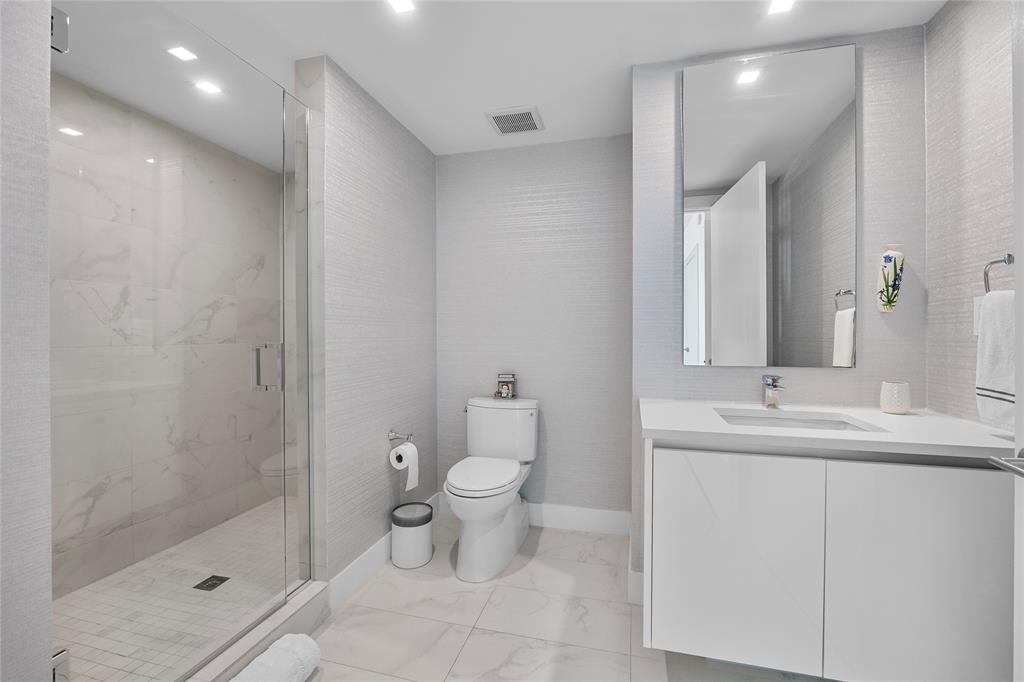 730 North Ocean Boulevard, Unit 1501 Pompano Beach, FL 33062 - Photo 27 of 56 a bathroom with a sink toilet and shower