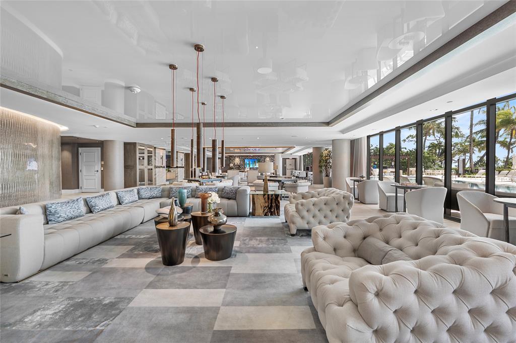 730 North Ocean Boulevard, Unit 1501 Pompano Beach, FL 33062 - Photo 32 of 56 a living room with furniture and a chandelier