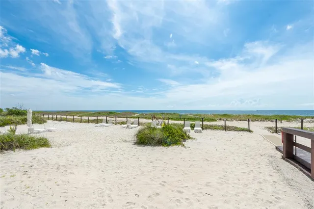 a view of a city from a balcony with outdoor seating