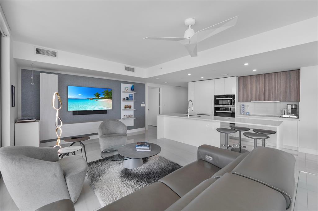 730 North Ocean Boulevard, Unit 1501 Pompano Beach, FL 33062 - Photo 8 of 56 a living room with furniture and a flat screen tv