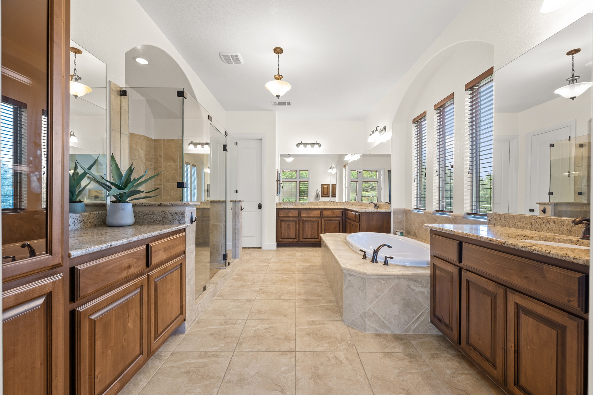 1301 Lions Lair Leander, TX 78641 - Photo 17 of 40 Spa-like primary bath with separate vanities and soaking tub
