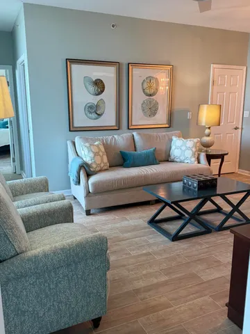 a living room with furniture and a painting on the wall