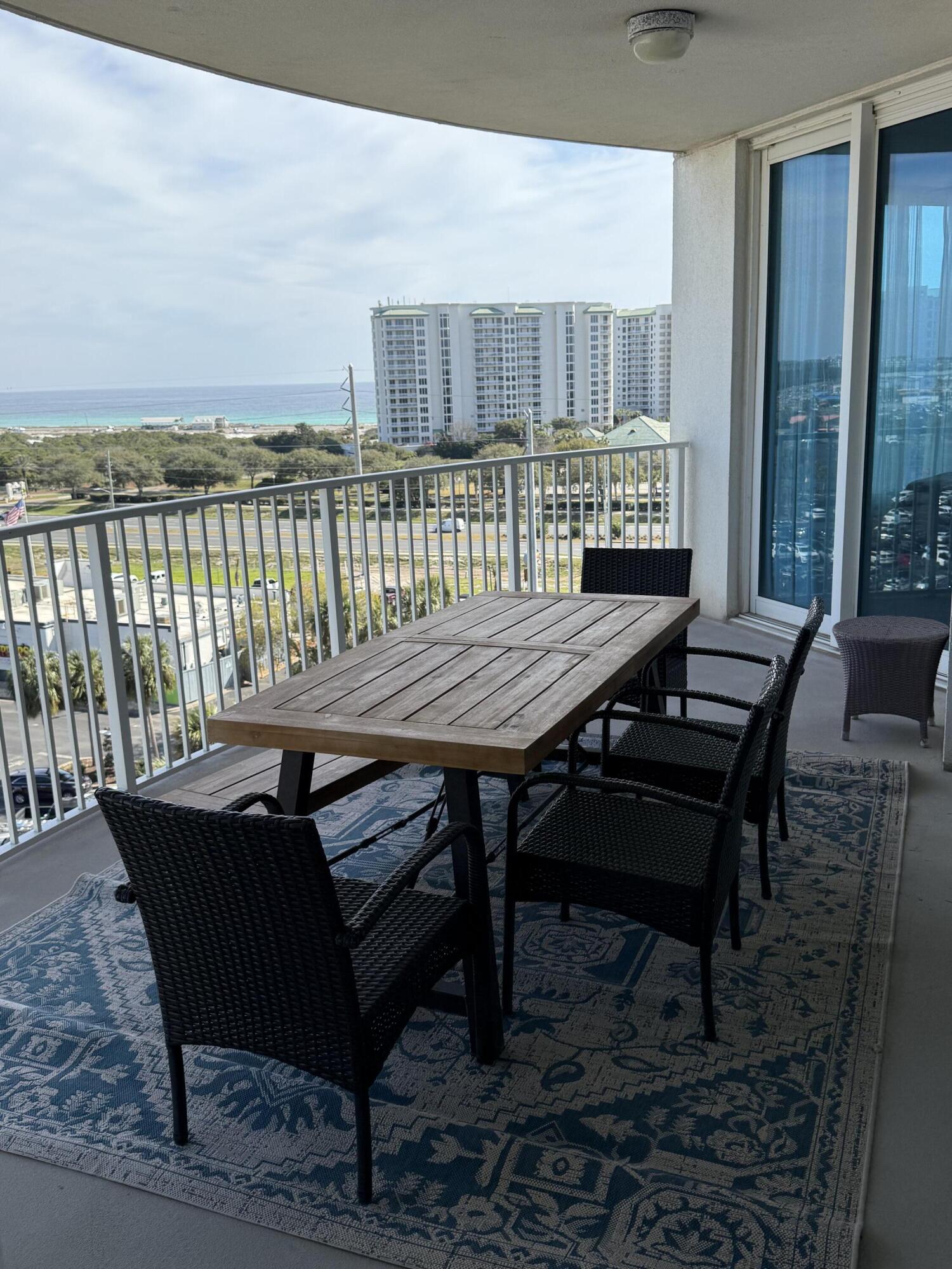 4203 Indian Bayou Trail, Unit 1816 Destin, FL 32541 - Photo 9 of 17 a view of a dining room with furniture window and wooden floor