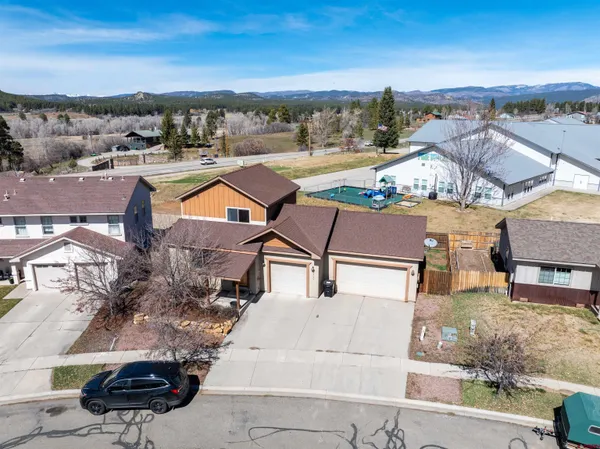 an aerial view of a house with a yard pool an outdoor seating