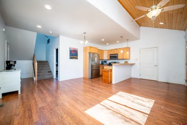 a view of kitchen with wooden floor and electronic appliances