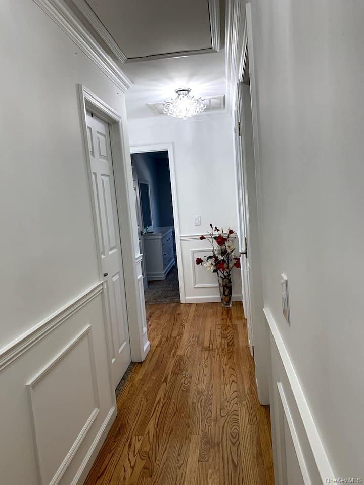 1 Brittany Court Ridge, NY 11961 - Photo 18 of 40 a view of a hallway with wooden floor and staircase