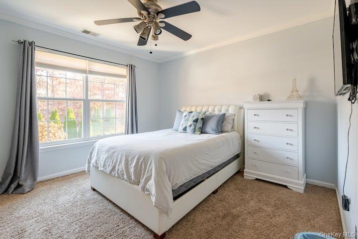 1 Brittany Court Ridge, NY 11961 - Photo 21 of 40 a bed sitting in a bedroom next to a window