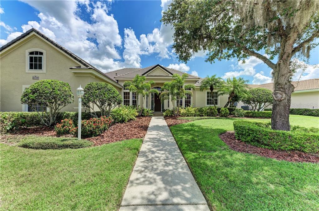 6523 The Masters Avenue Lakewood Ranch, FL 34202 - Photo 1 of 1 a front view of a house with a yard