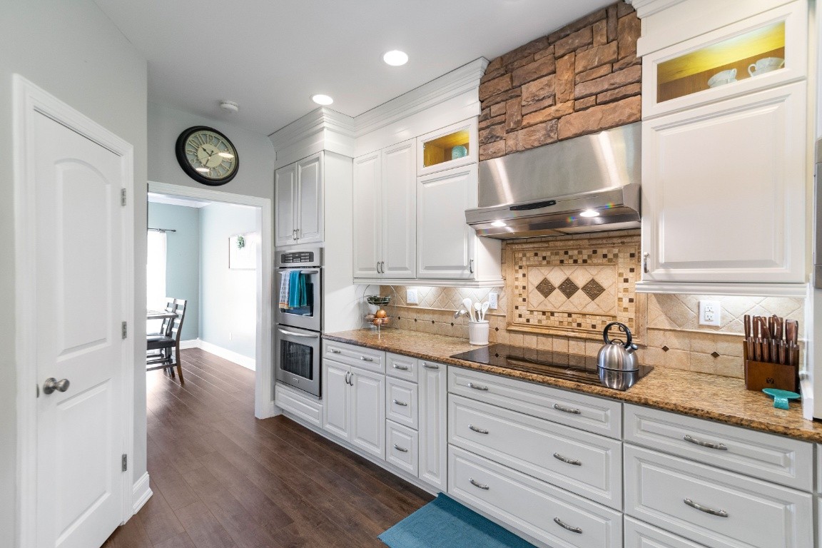 2099 Double Branch Road Columbia, TN 38401 - Photo 8 of 43 a kitchen with granite countertop white cabinets and white appliances