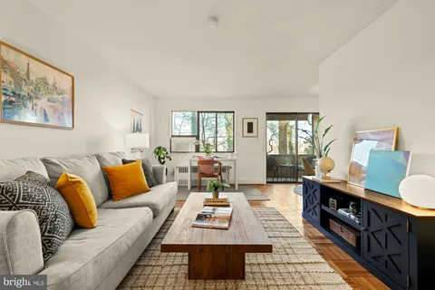 a living room with furniture and wooden floor