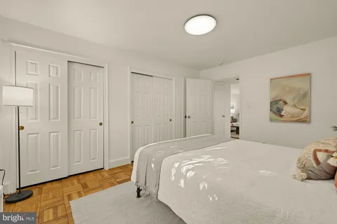 a bedroom with a bed and a painting on the wall