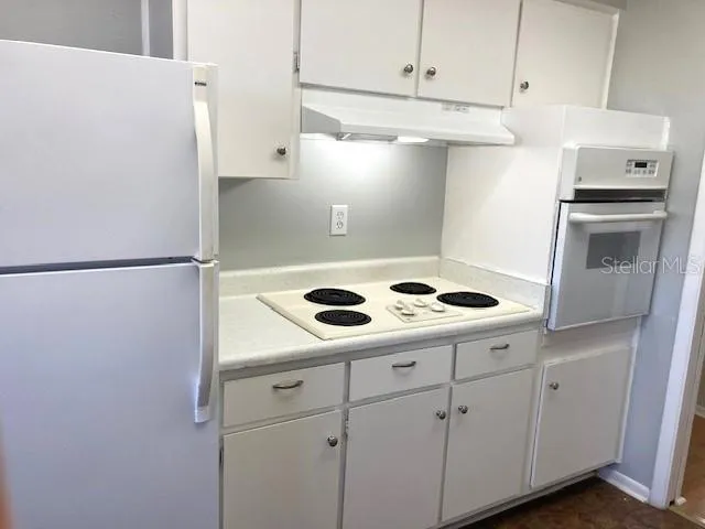 a view of a kitchen with appliances and cabinets